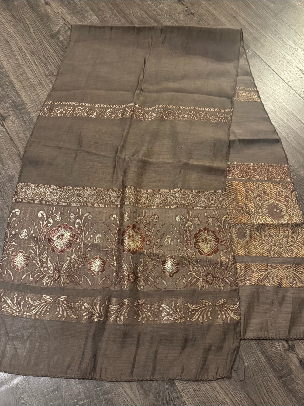 Brown tissue silk scarf featuring intricate golden floral embroidery.